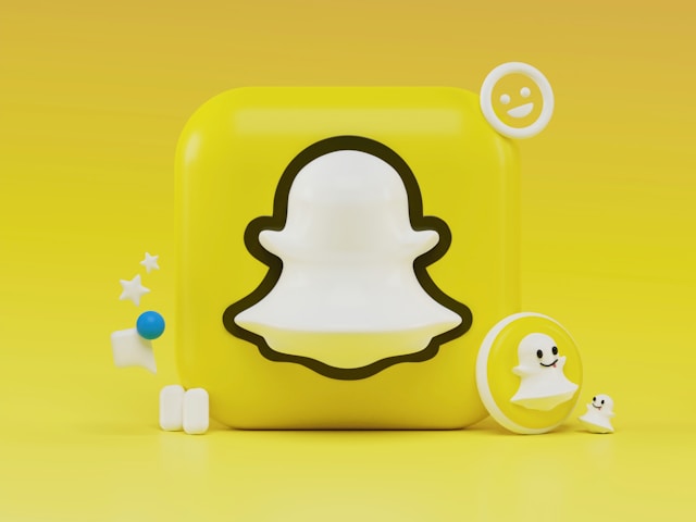 A 3D Snapchat logo with playful icons on a bright yellow background."