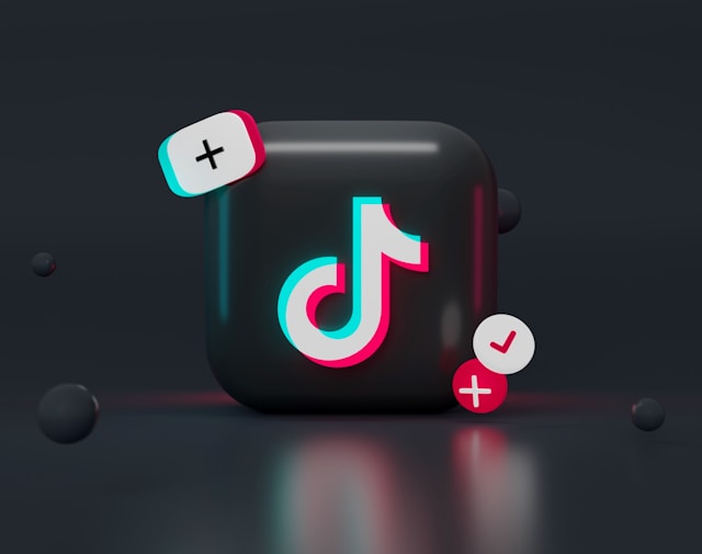 A 3D TikTok logo with floating plus and checkmark icons on a dark background."